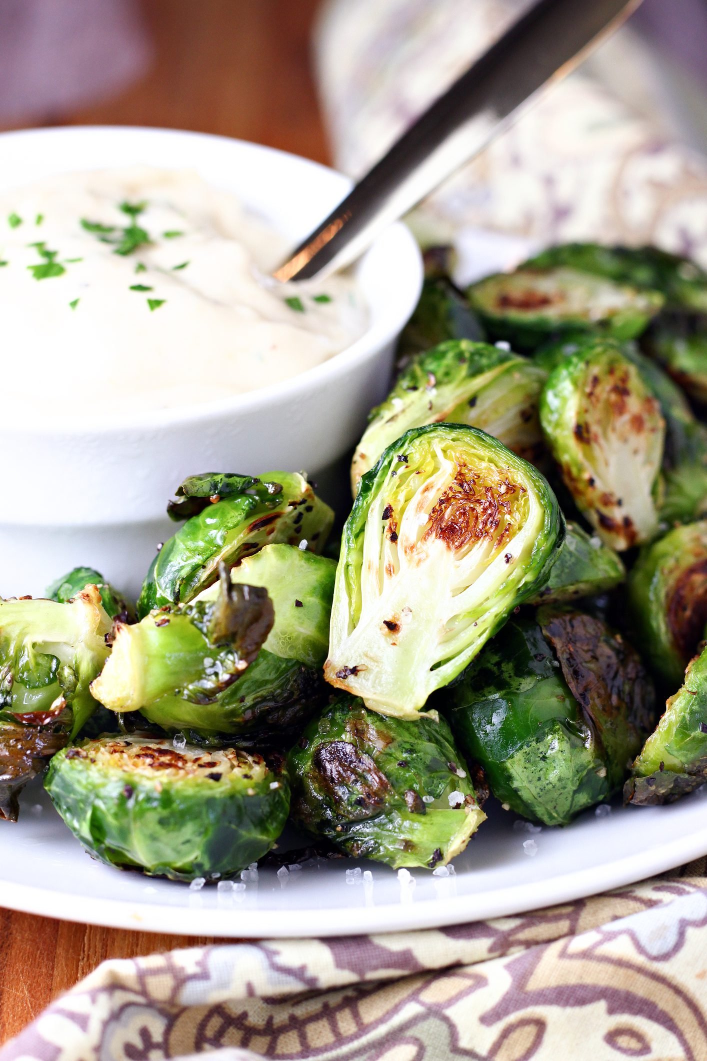 Roasted Brussels Sprouts Alongside a Tangy Garlic Sauce